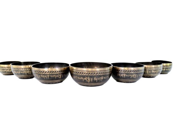 meditating buddha with sacred om, chakra, and mandala symbols 7 chakra singing bowls set